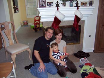 Mom Dad and me on my second christmas